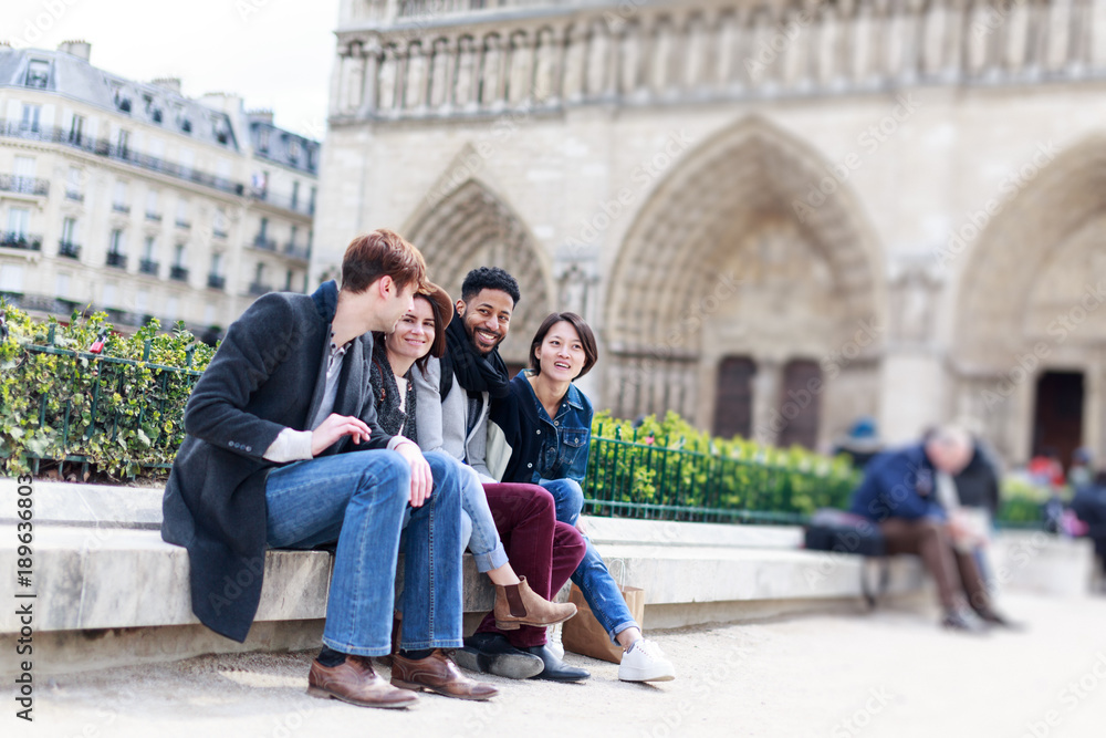 Fototapeta premium Multi-ethnic Group Of Friends Having Fun In Paris, Notre Dame