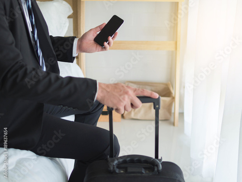 Asia businessman using phone sitting in hotel room on business trip japan korea china