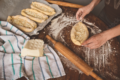 cooking khachapuri with cheese on a table photo