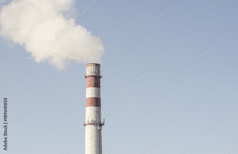 A coal-fired plant produces smoke into the sky, thereby sucking up the earth's atmosphere. Smoke from a chimney against a blue sky A coal-fired plant produces smoke into the sky, thereby sucking up the earth's atmosphere. Smoke from a chimney against a blue sky