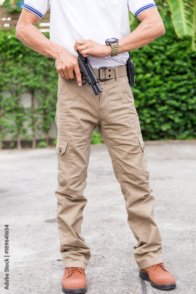 man in cargo pants with gun man in cargo pants with gun