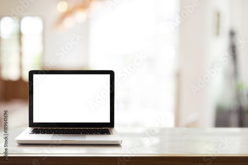blank laptop display on table with window light