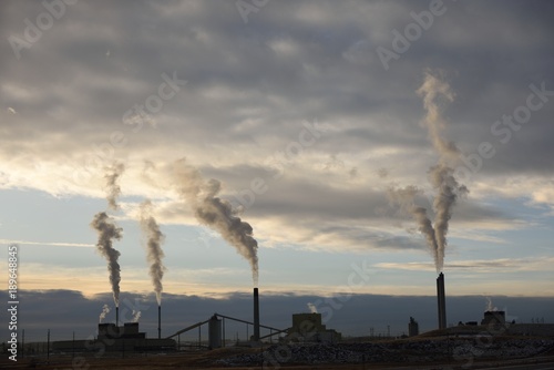 Coal fired smokestack emission plumes, silhouette at sunset, Wyoming photo