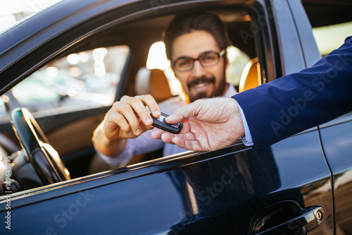 Принти на полотні Young and handsome businessman buying used car.