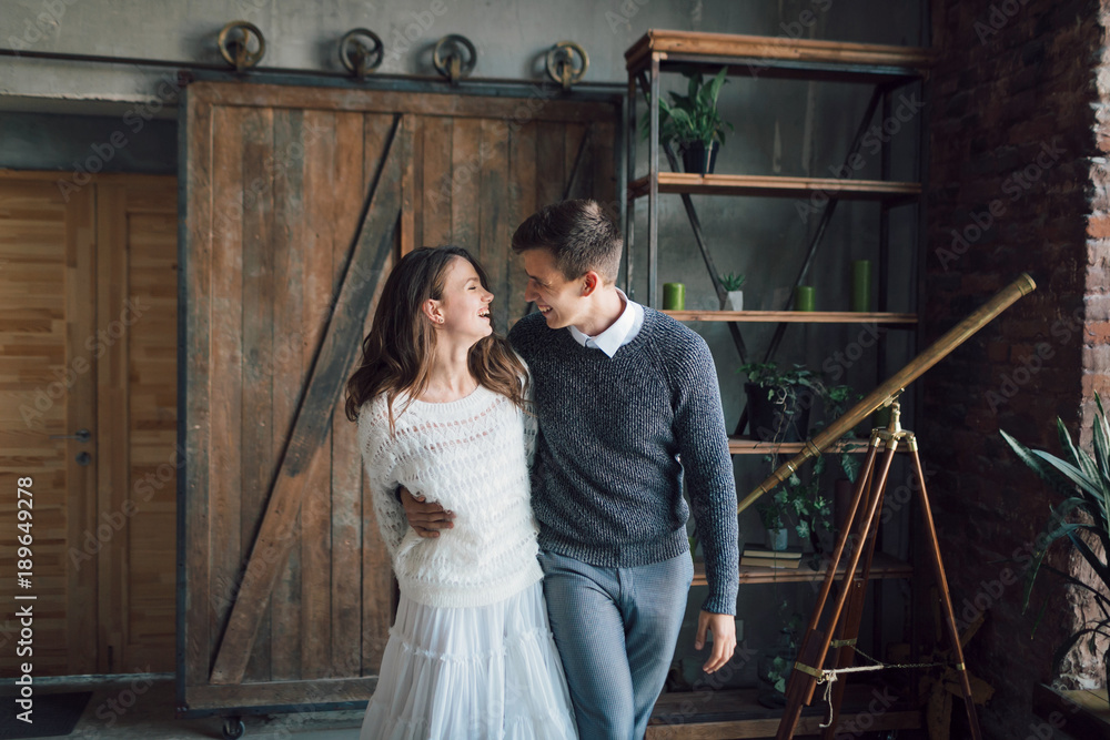 Cheerful couple having fun together. Newlyweds laughing and go crazy. Artwork. Wedding indoors. Soft focus