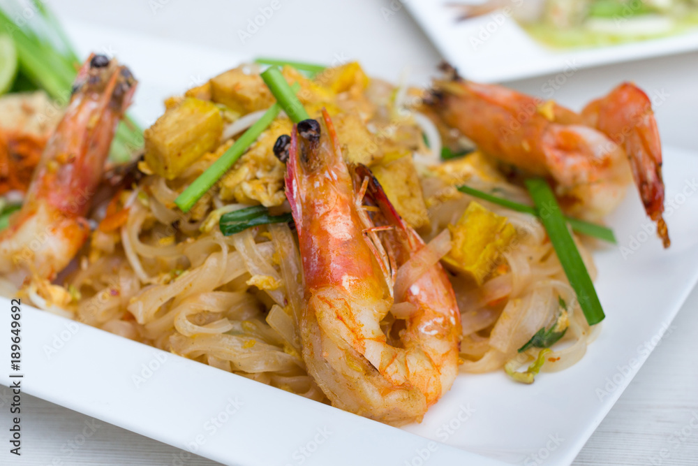 stir-fried rice noodles with fresh shrimp and tofu(Pad Thai),in white dish. stir-fried rice noodles with fresh shrimp and tofu(Pad Thai),in white dish.