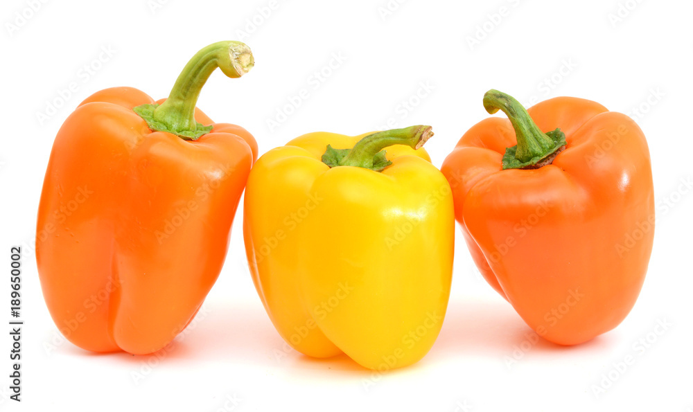 three sweet pepper orange, and yellow with bright green steam with white light and the water drops diet pepper, isolated on white background three sweet pepper orange, and yellow with bright green steam with white light and the water drops diet pepper, isolated on white background
