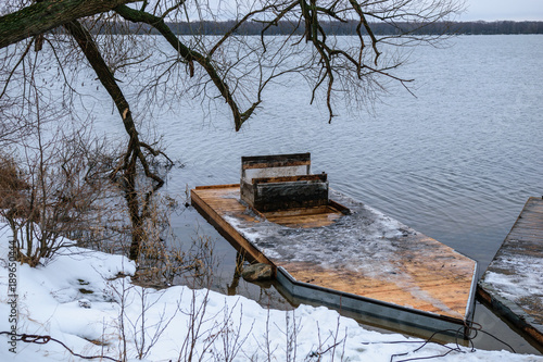 Sunken fishing boat on winter lake in Shatura in Moscow Region, Russia photo