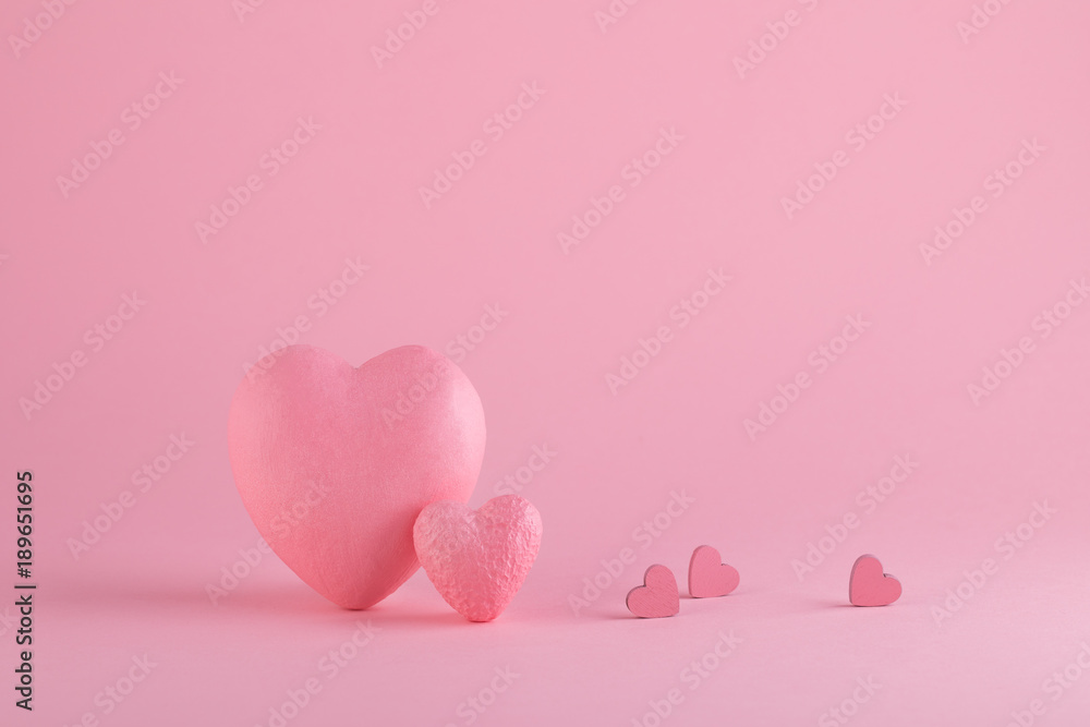 Big and small hearts on the pink background. Love and St. Valentine's Day