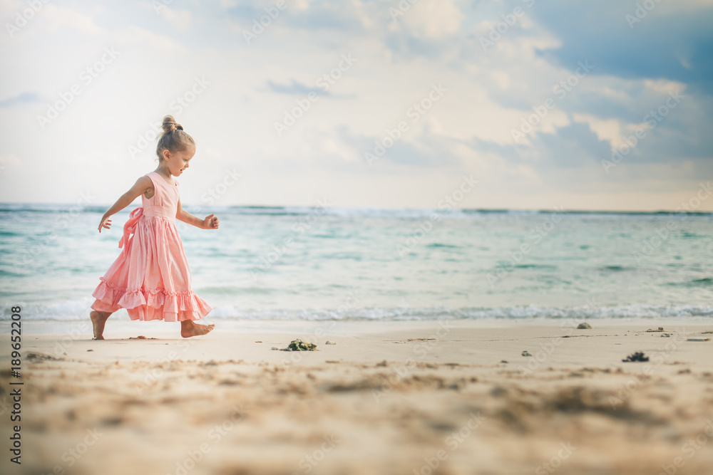 Beautiful little girl at the beach. Sunblock cream for children. Beautiful little girl at the beach. Sunblock cream for children.