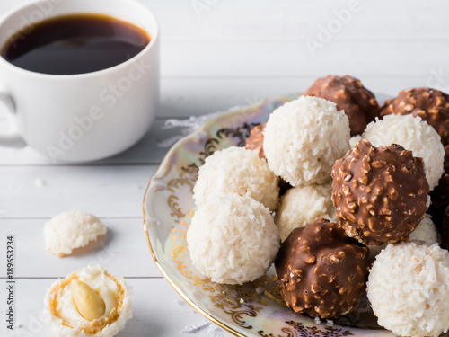 Chocolate and Coconut Candies in a Bowl on a Wooden tray Coffee Cup Orchid.