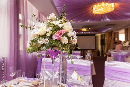 A wedding bouquet is on the table in the background of the hall. Bridal bouquet.