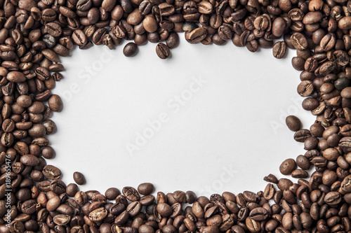 A frame made of coffee in beans with a white background for the text in the middle.