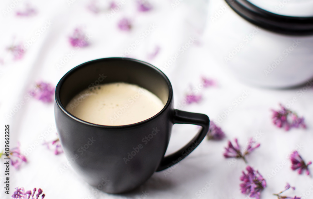 Cup of coffee with milk on a table Cup of coffee with milk on a table