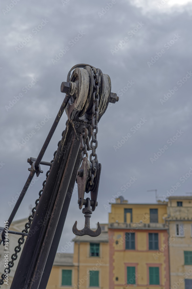old crane in the harbour of camogli