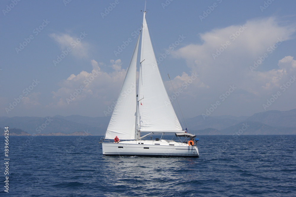 Sailing boat Bavaria`11 36 feets float under sail in sunny day. Europe. Mediterranean sea. Sud-western coast of Turkey. May 2012.