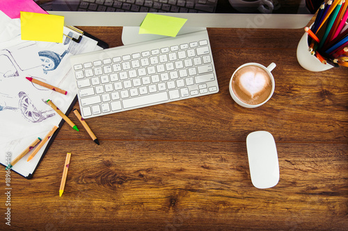 Modern office workplace with digital tablet, notepad, colorful pencils, glasses, in morning