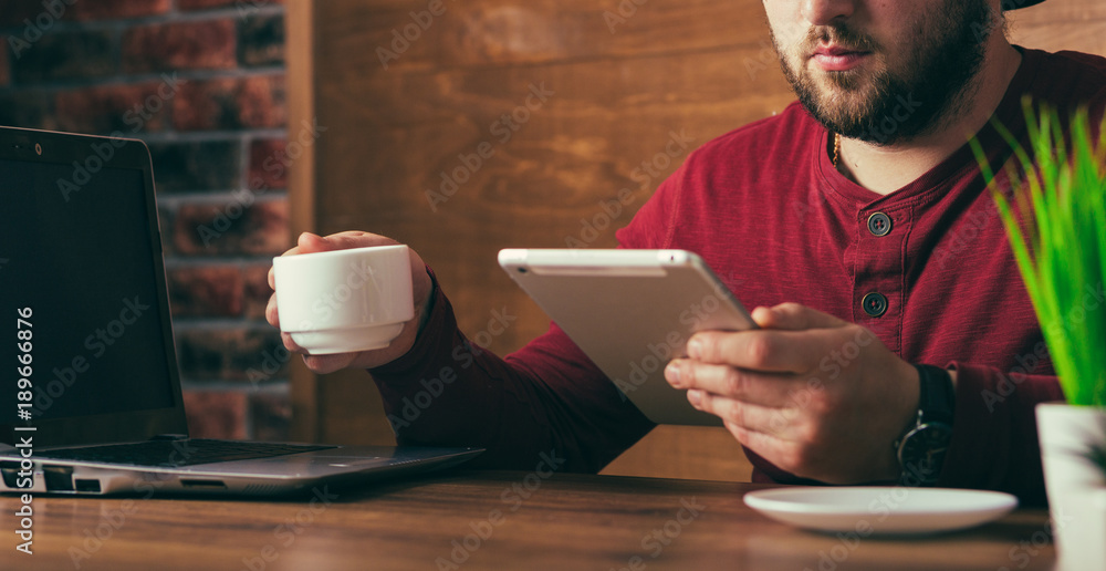 young handsome freelance artist in cafe or office young handsome freelance artist in cafe or office