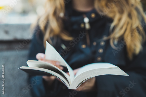 Mid section of woman reading a book photo