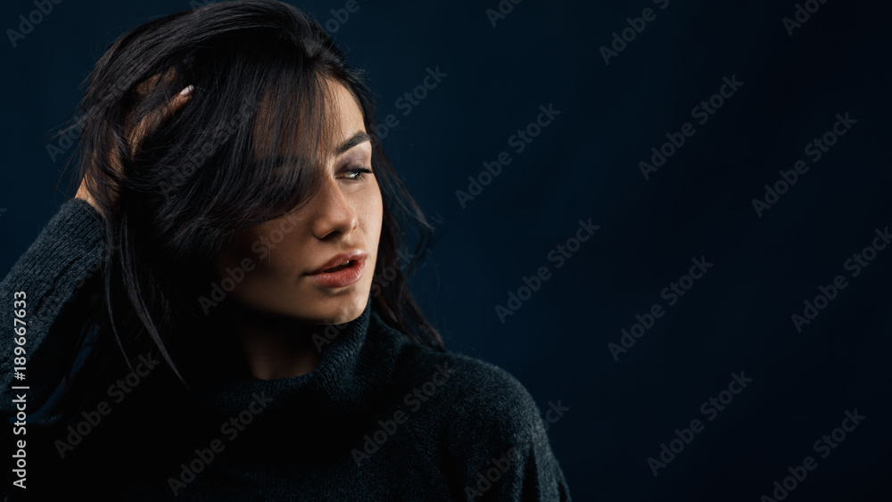 Side view portrait of a beautiful woman in black sweater Side view portrait of a beautiful woman in black sweater