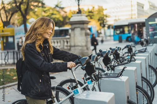 Woman taking bicycle in park