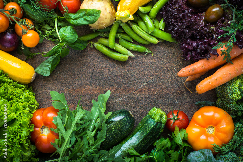 Organic farmer vegetables on dark slate table. Top view. Food frame background. Organic farmer vegetables on dark slate table. Top view. Food frame background.