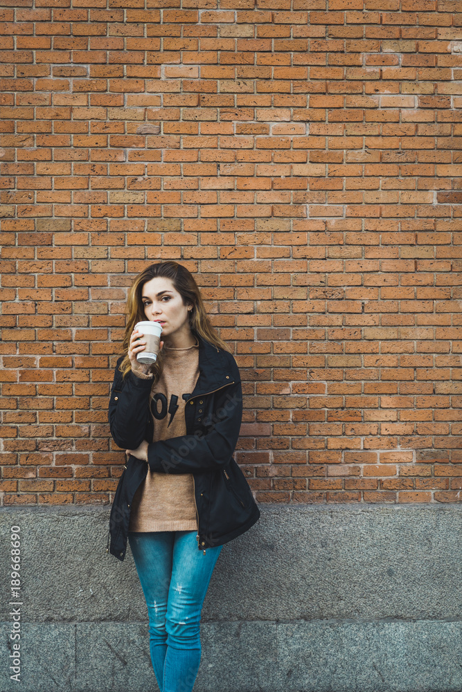 Woman with paper cup on street Woman with paper cup on street