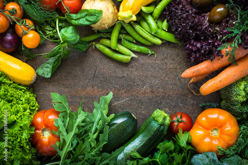 Organic farmer vegetables on dark slate table. Top view. Food frame background.