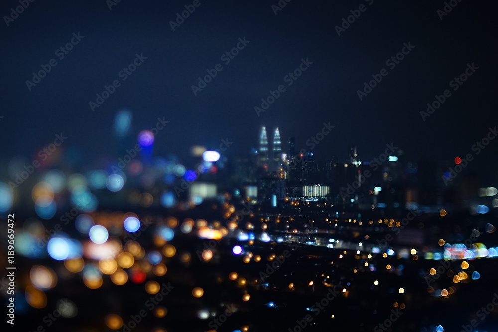 Blurred dramatic night view of city with abstract of LED, neon lights and beautiful bokeh.