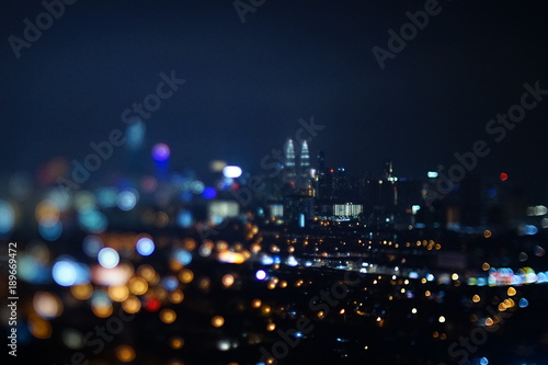 Blurred dramatic night view of city with abstract of LED, neon lights and beautiful bokeh.