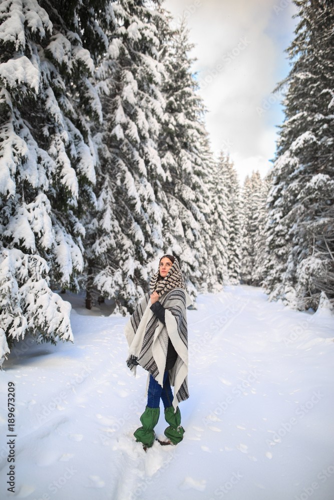 Happy young woman walking in winter time. Happy girl having fun in the snow. Snow covered trees in the winter sun light. Snowy pine trees on a winter landscape. snovy trees on winter mountains