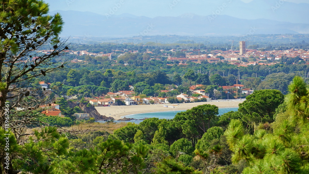 Mediterranean beach of the Racou in Argeles-sur-Mer with the village in background, Roussillon, Pyrenees Orientales, France