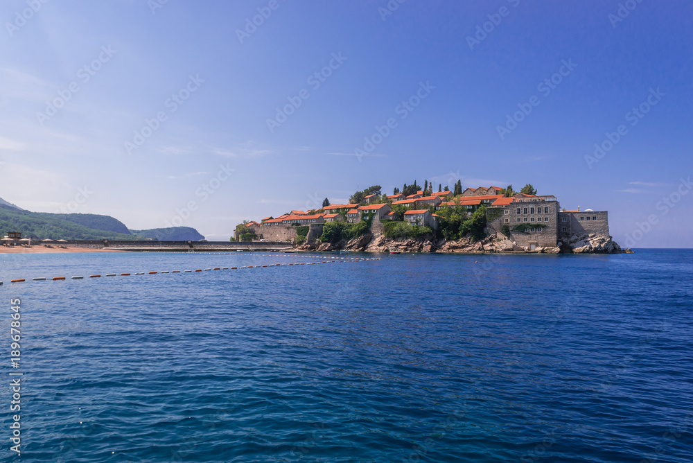Distance view of small Island of Sveti Stefan on the Adriatic Sea in Montenegro