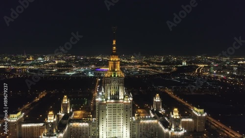 Moscow State University Main Campus and Illuminated Moscow Skyline at Clear Winter Night. Russia. Aerial View. Drone is Orbiting Around. Establishing Shot..