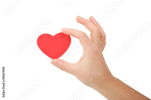 hand holding small bright red heart on white background