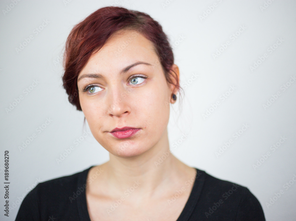 A young girl expressing her face, and her hands showing her idea, white background, studio, facial expressions A young girl expressing her face, and her hands showing her idea, white background, studio, facial expressions