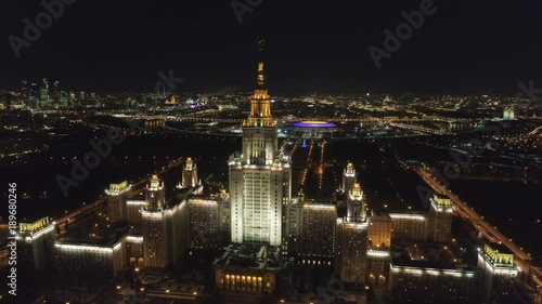 Moscow State University Main Campus and Illuminated Moscow Skyline at Clear Winter Night. Russia. Aerial View. Drone is Flying Forward and Approaching to Spire. Establishing Shot..