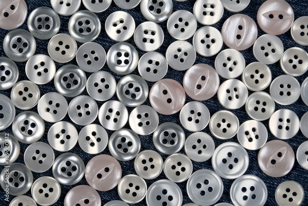 different mother of pearl buttons on blue fabric different mother of pearl buttons on blue fabric