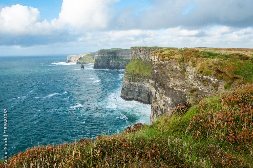 The Cliffs of Moher, Irelands Most Visited Natural Tourist Attraction, are sea cliffs located at the southwestern edge of the Burren region in County Clare, Ireland. The Cliffs of Moher, Irelands Most Visited Natural Tourist Attraction, are sea cliffs located at the southwestern edge of the Burren region in County Clare, Ireland.