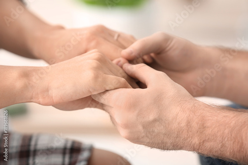 Happy couple holding hands after reception of family psychologist