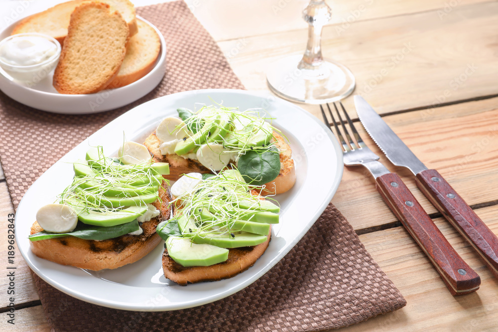 Tasty bruschettas with avocado slices on plate Tasty bruschettas with avocado slices on plate