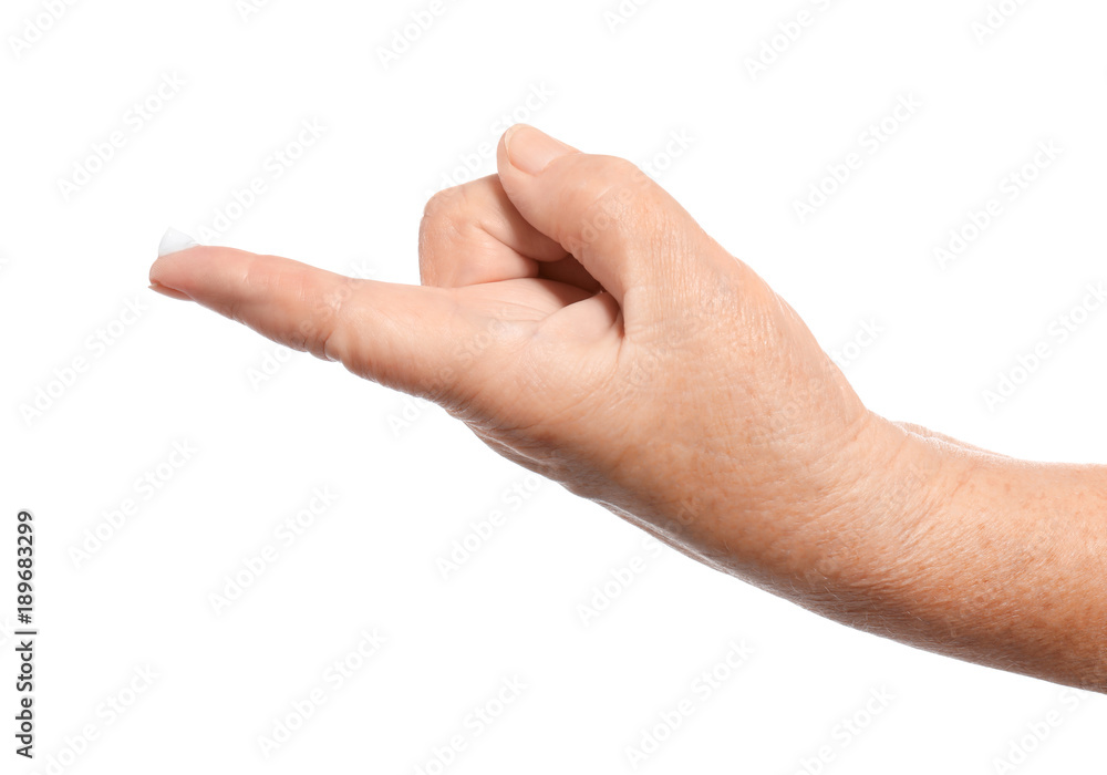 Hand of senior woman with cream on finger, against white background Hand of senior woman with cream on finger, against white background