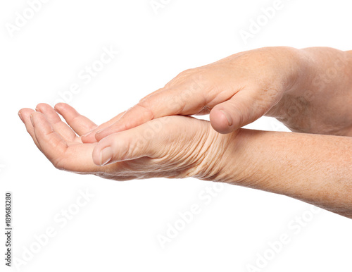 Hands of senior woman with healthy skin softened by cream with moisturizing effect, on white background © Africa Studio