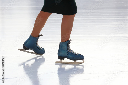 feet skating girl skating on ice rink.