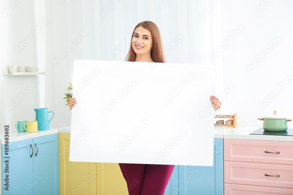Young woman with blank advertising board indoors Young woman with blank advertising board indoors