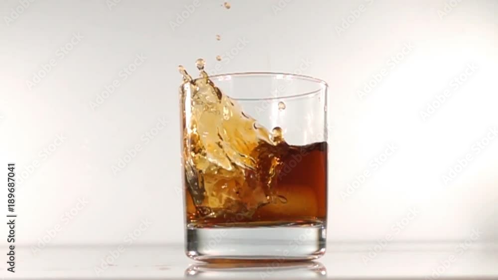 ice falls into a glass of water slow motion ice falls into a glass of water slow motion