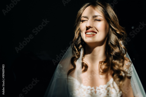 Woman in silk robe with open shoulders looks seductive
