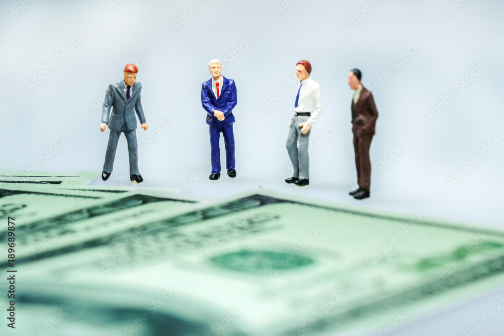 Miniature people : Businessman with US dollar bills. Miniature people : Businessman with US dollar bills.