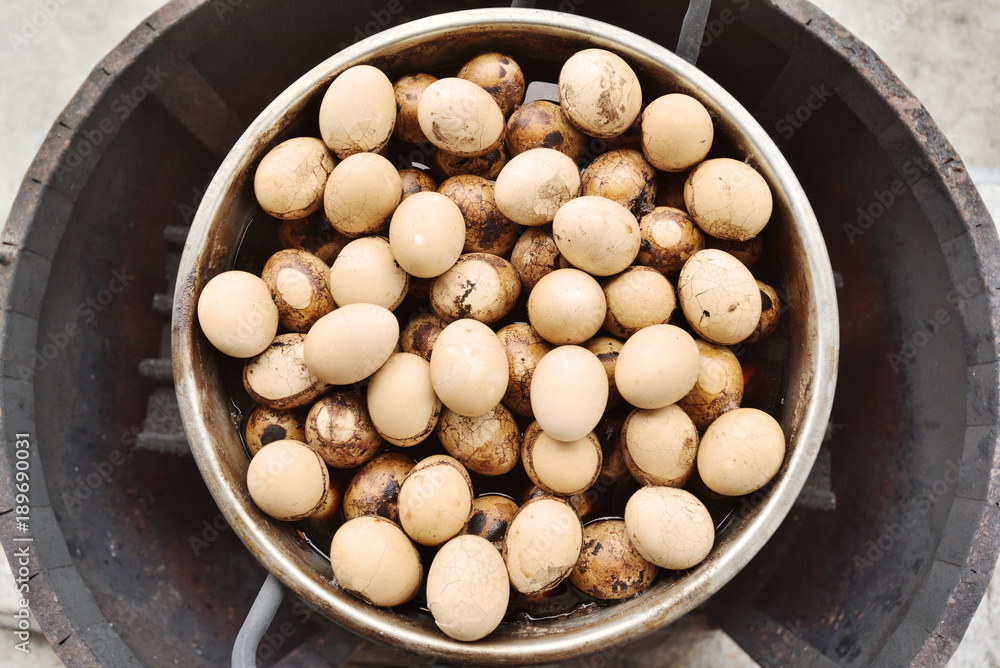 Boiling eggs with tea, sauce and spices in steel pot. Boiling eggs with tea, sauce and spices in steel pot.