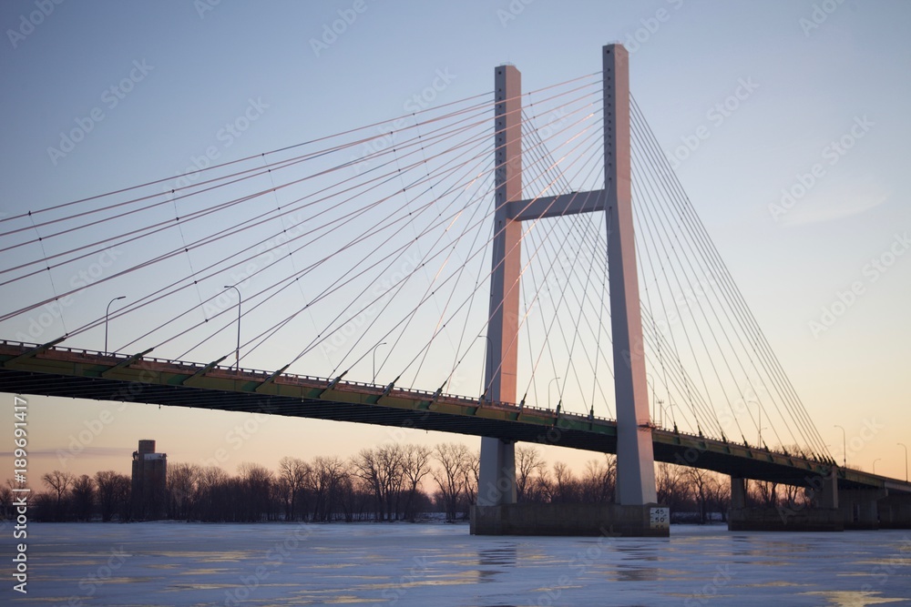 Bridge and a frozen river at sunrise